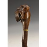 A carved blackthorn walking stick, retriever with duck, soft cloth case,