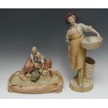 A large Royal Dux figure, of a gentleman with a large basket, in tones of green and mustard,