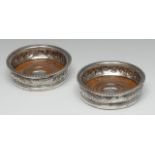 A pair of George IV silver bowed circular wine coasters,