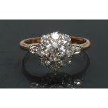 A diamond cluster ring, central round brilliant cut diamond approx 0.