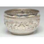 An Indian silver circular bowl, chased in high relief with figures in a landscape, 15cm diam, c.