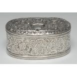 A Turkish silver oval box and cover, chased with baskets of flowers and scrolls, 12cm wide,
