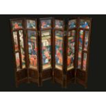 A Chinese hardwood six fold screen, incorporating 18th century reverse painted panels,