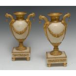 A pair of late 18th century Louis XVI/Directoire ormolu-mounted marble mantel urns,