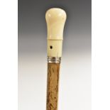 A late William III/early Queen Anne gentleman's silver-mounted ivory and malacca walking stick,