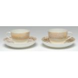 A pair of Pinxton Bute-shaped teacups and saucers, pattern 1, gilt seaweed version, the saucers 14.