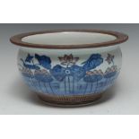 A Chinese fish bowl, painted in tones of underglaze blue and manganese with lilies and water plants,