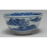 A Chinese porcelain circular bowl, painted in underglaze blue with a stylized panoramic landscape,