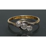 A diamond trilogy twist ring, central old brilliant cut diamond approx 0.