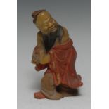 A Chinese soapstone carving, of Shou Lao, clutching the peach symbolic of longevity,