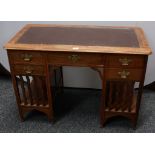 An Arts and Crafts oak rectangular desk, in the manner of Liberty & Co,