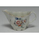 A Worcester low Chelsea ewer, painted with coloured flowers, gilt line border, c.