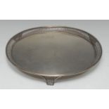 A George V silver circular tray, pierced border, and feet, 31cm diam,