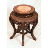 A Chinese hardwood jardiniere stand, circular top with raised plateau centred by a soapstone panel,