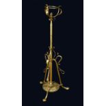 An Art Nouveau brass standard lamp, in the manner of WAS Benson,