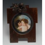 A German porcelain circular plaque, painted with a mother and her child,