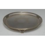 A George V silver circular tray, pierced border and feet, 20.