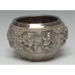 An Indian silver circular bowl, chased in high relief with a band of deities, peacock to base,