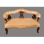 A Victorian walnut sofa, shaped serpentine cresting rail above pierced and carved splats,