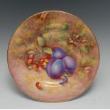 A Royal Worcester circular plate, painted by John Freeman, signed, with plums and cherries,