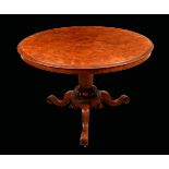 An early Victorian walnut circular centre table, quarter-veneered top above a deep frieze,