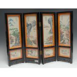 A Chinese four fold table screen, the porcelain panels decorated with monumental landscapes,