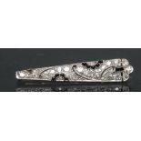 An Art Deco diamond and black stone brooch,