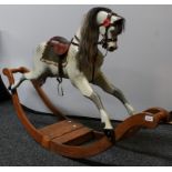 An Edwardian rocking horse, carved, gesso and painted as a dapple grey,