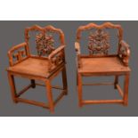 A pair of Chinese hardwood scholar's chairs, each shaped back with pierced splat,