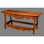An 18th century Continental walnut serving table, oversailing top with staved ends,