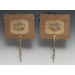 A pair of 19th century giltwood, embossed card and petit point hand screens,