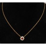 A ruby and diamond pendant necklace, central round cur red ruby approx 0.