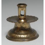 A 16th century brass capstan candlestick, pierced cylindrical sconce,
