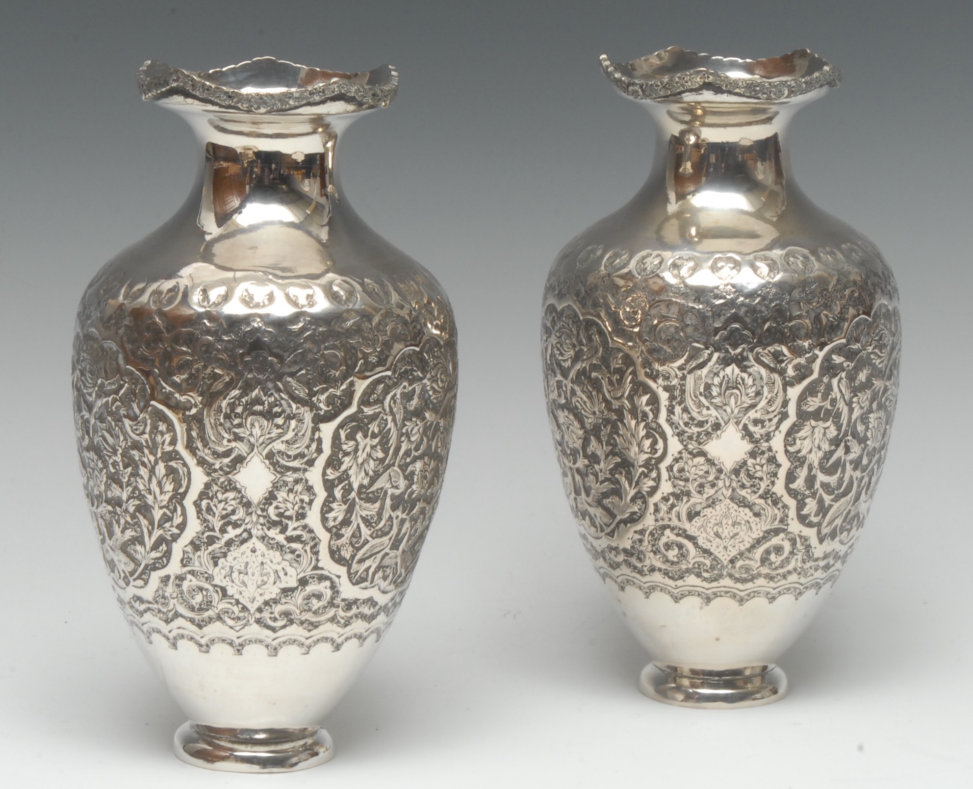 A pair of Persian Islamic silver ovoid vases,