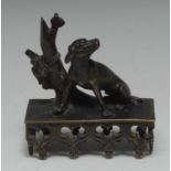 A Regency brown-patinated library bronze, of a faithful hound by a tree stump, rectangular base,