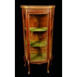 A French Louis XV Revival gilt metal mounted mahogany shaped serpentine vitrine,