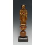 A 19th century Chinese polychrome softwood carving, of an Immortal,