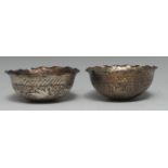 A pair of Middle-Eastern white metal shaped circular bowls,