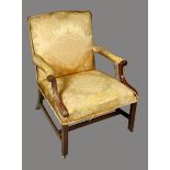 A George III mahogany Gainsborough chair, stuffed over upholstery,