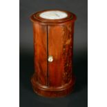 A Victorian mahogany cylindrical pot cupboard, turned top with inset marble panel, above a door,