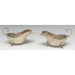 A pair of large Edwardian silver sauce boats, of George III design, flying-scroll handles,