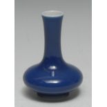 A Chinese monochrome compressed ovoid vase, glazed in tones of blue, 10cm high,