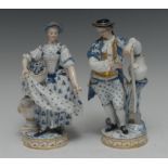 A pair of Meissen figures, The Gardeners, both in 18th century costume, he holding a flower posy,