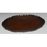 A George III mahogany shaped oval tray, piecrust border,
