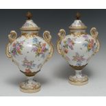 A pair of Meissen ogee shaped pedestal two handled urns and covers,