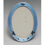A George V silver and enamel oval easel photograph frame, 17cm high,