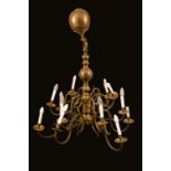 A William and Mary style brass twelve light electrolier, scroll branches,