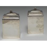 A pair of early George III silver rectangular tea caddies, push-fitting covers with bud finials,