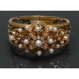 A 19th century diamond cultured pearl and black enamelled bangle,