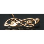 A Charles Rennie Mackintosh inspired Ortak diamond set love knot brooch,